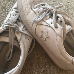 Slightly off white colored leather converse